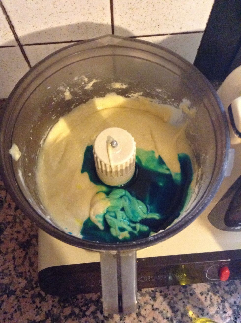 Add two teaspoons of yellow colouring and 5 teaspoons of blue colouring.