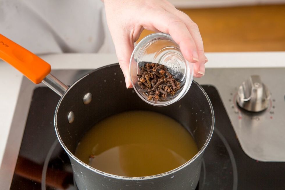 Add two whole cloves. Note: They're pretty small so make sure not to add too much!