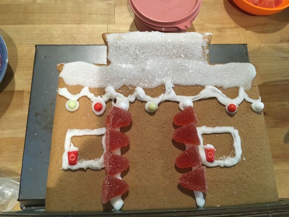 Add two windows with the candy frappcinos. Add a dot of frosting as creme. Now add gumdrops along the sides.