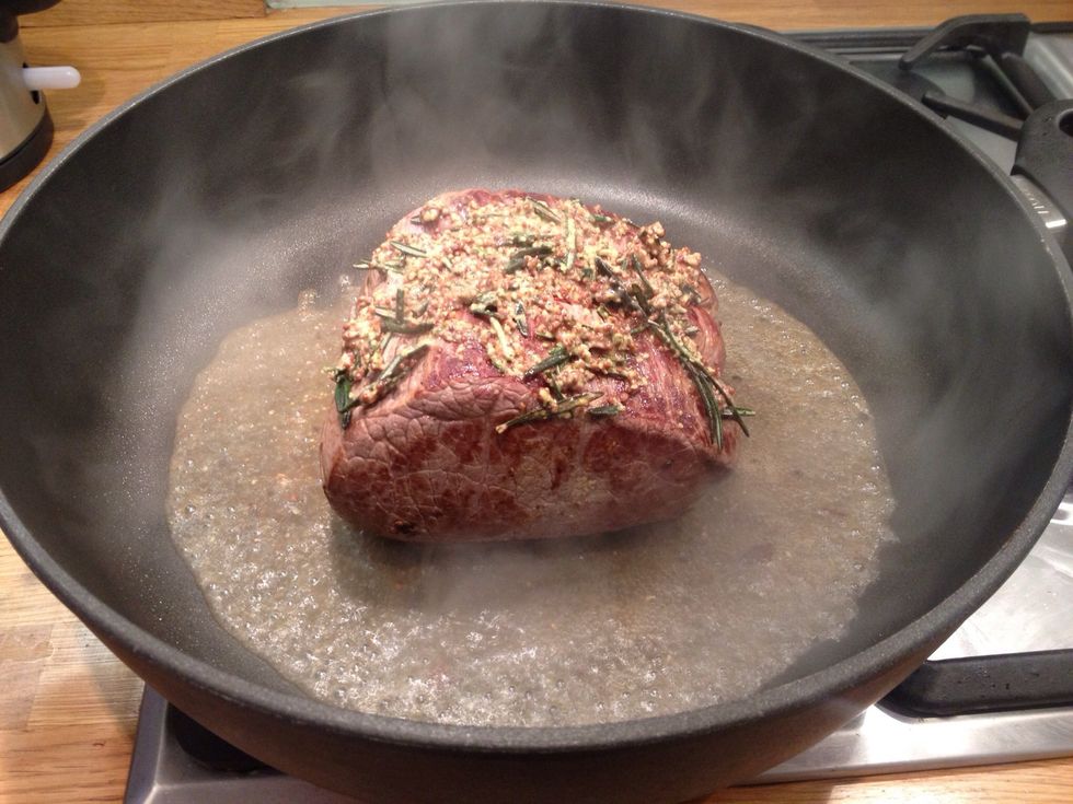 Add two wine glasses worth of water. Put it in the oven and immediately turn the temperature down to 180C. Roast it for 15 mins for every 450g of beef plus 20 mins. This joint was 900g so 50 mins