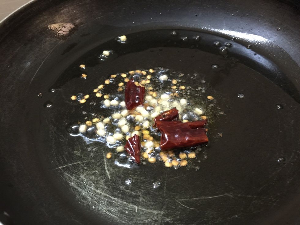 Add urad dal and dried red chilli