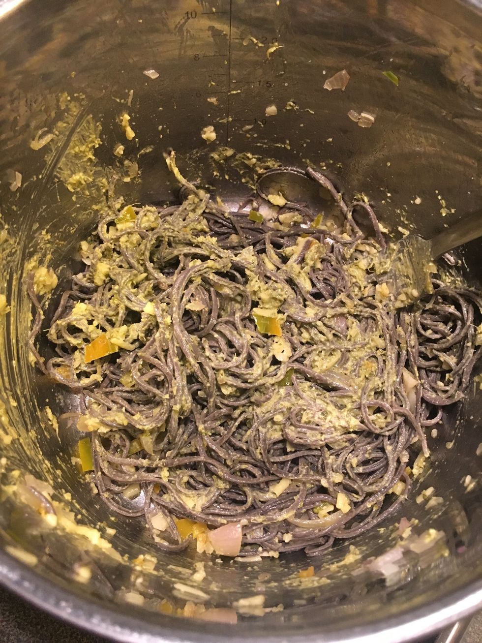 Add vegan shredded cheese and pesto. Continue to stir until incorporated.