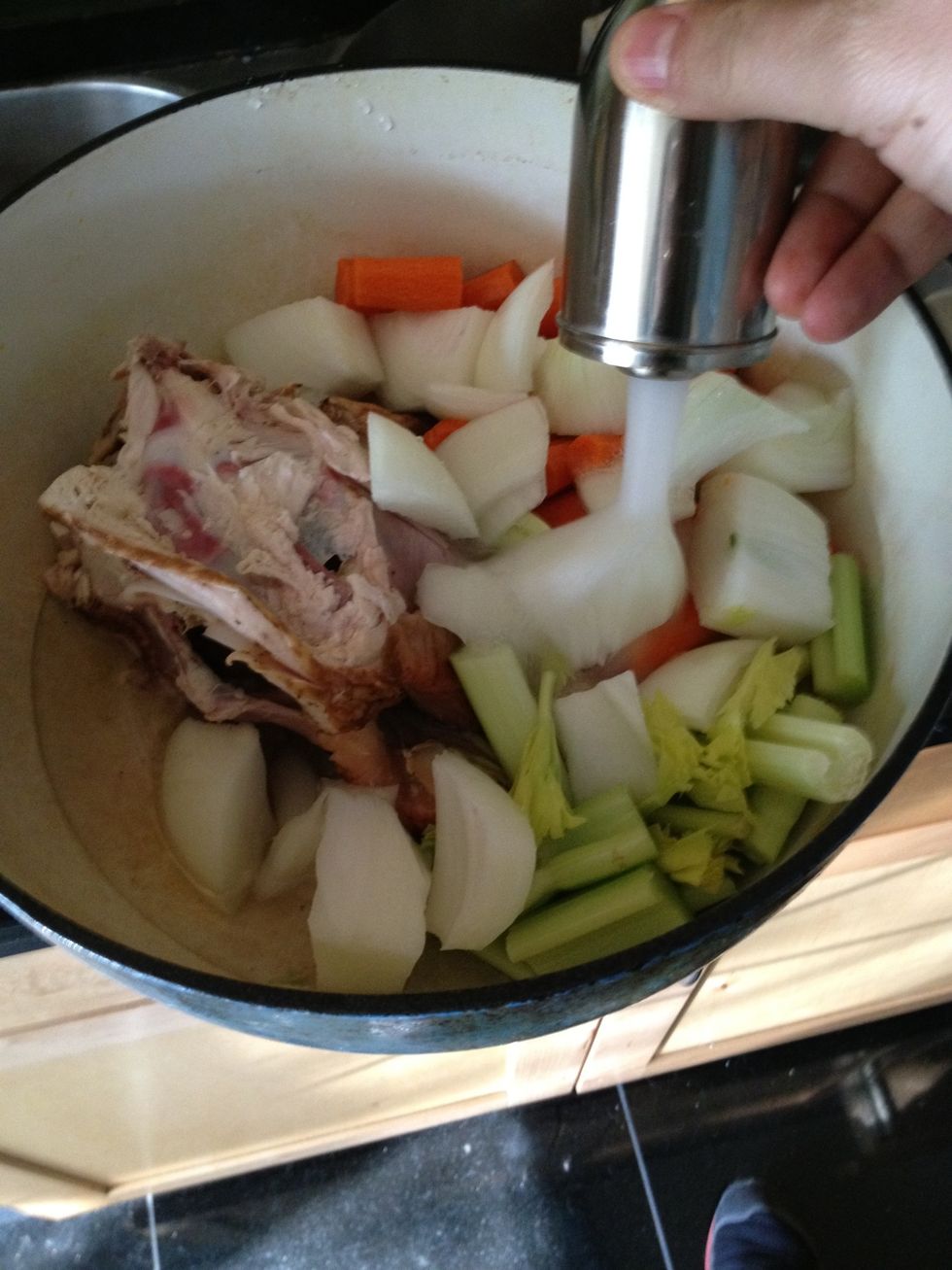 Add veggies and chicken to a large pot and add enough water to cover.