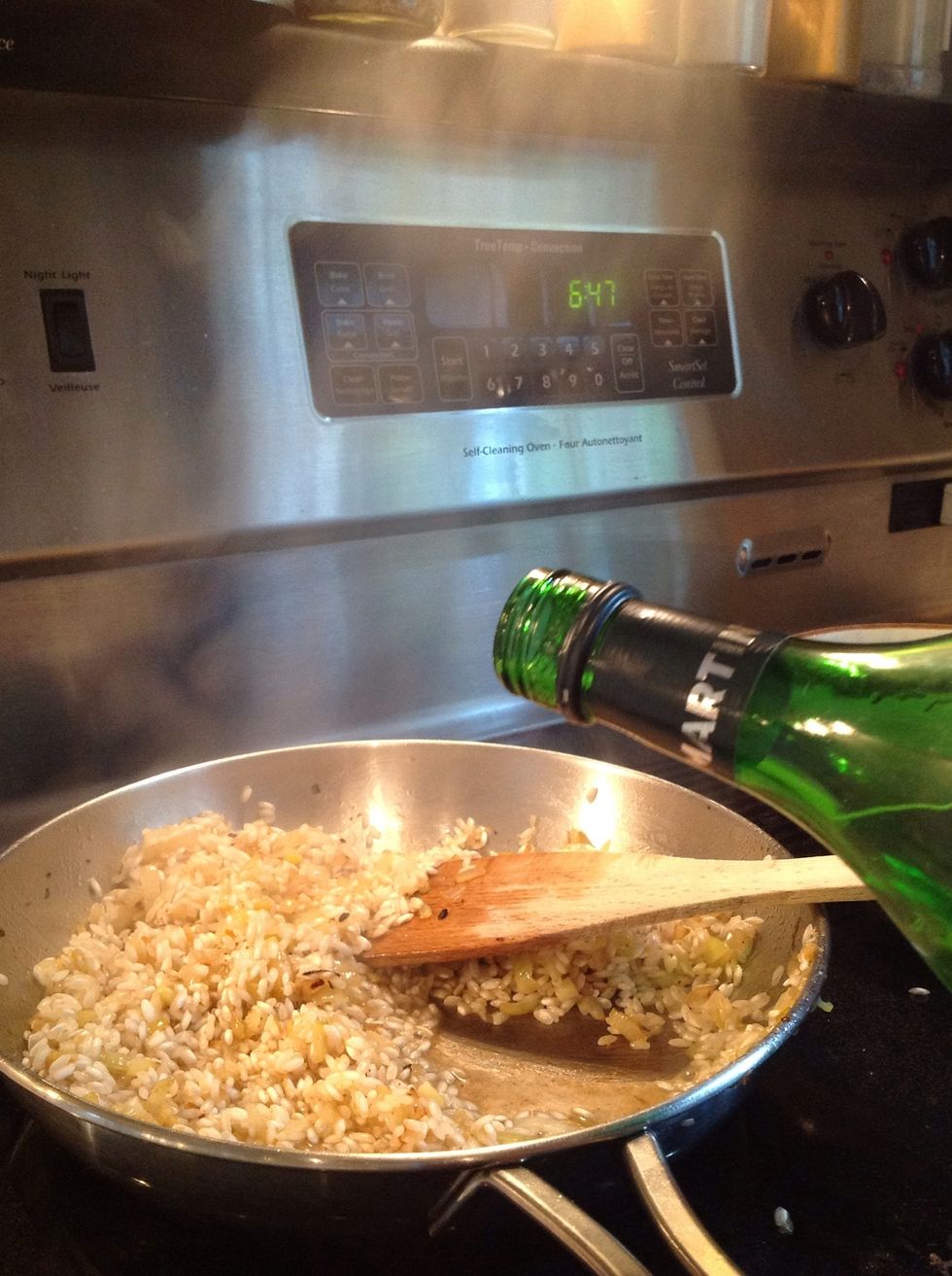 Add vermouth. Simmer, stirring, until it absorbs.