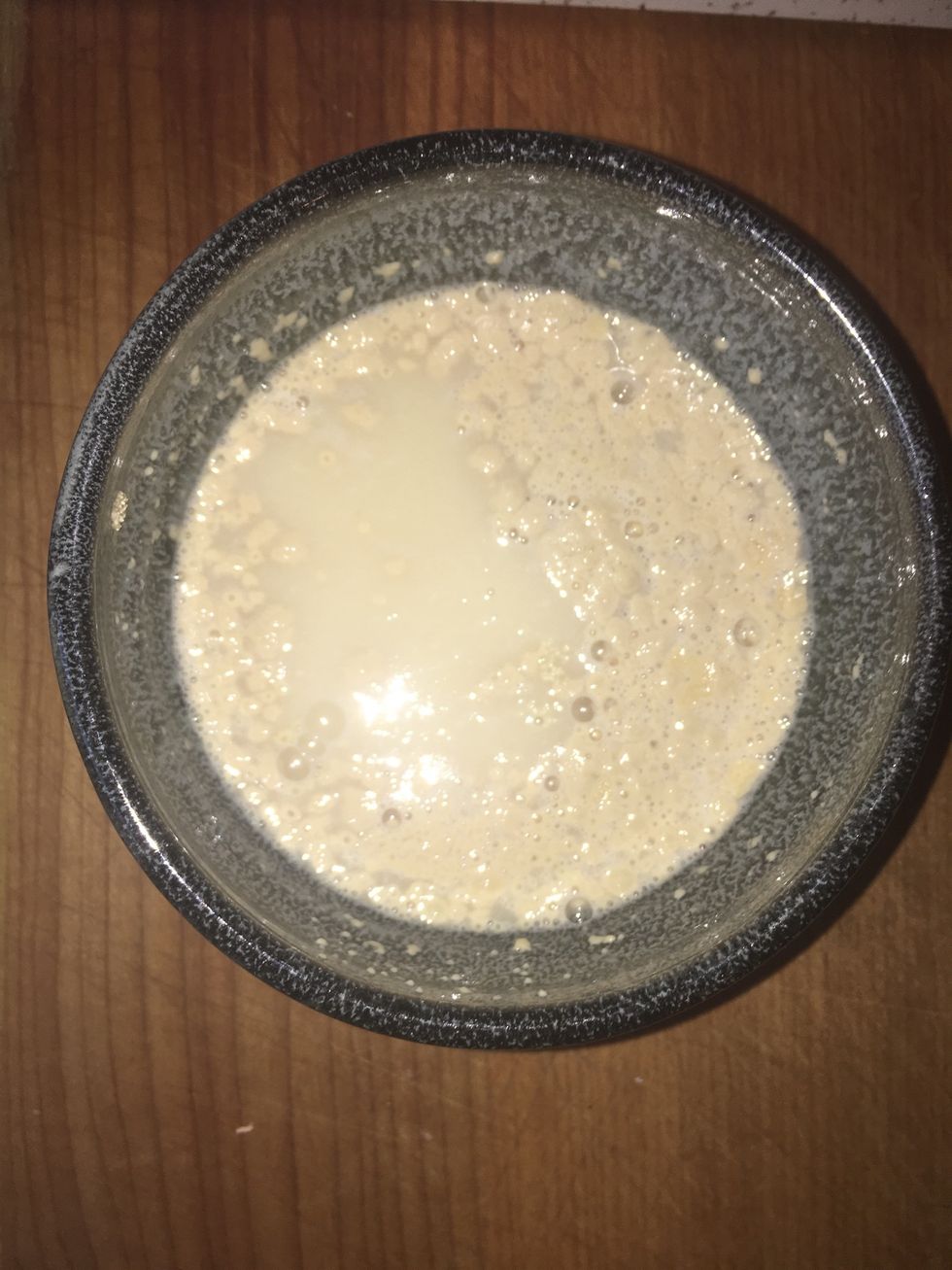 Add warm water to yeast and stir lightly. Add sugar to the yeast-water mixture and stir again. Let sit for 5-10 minutes