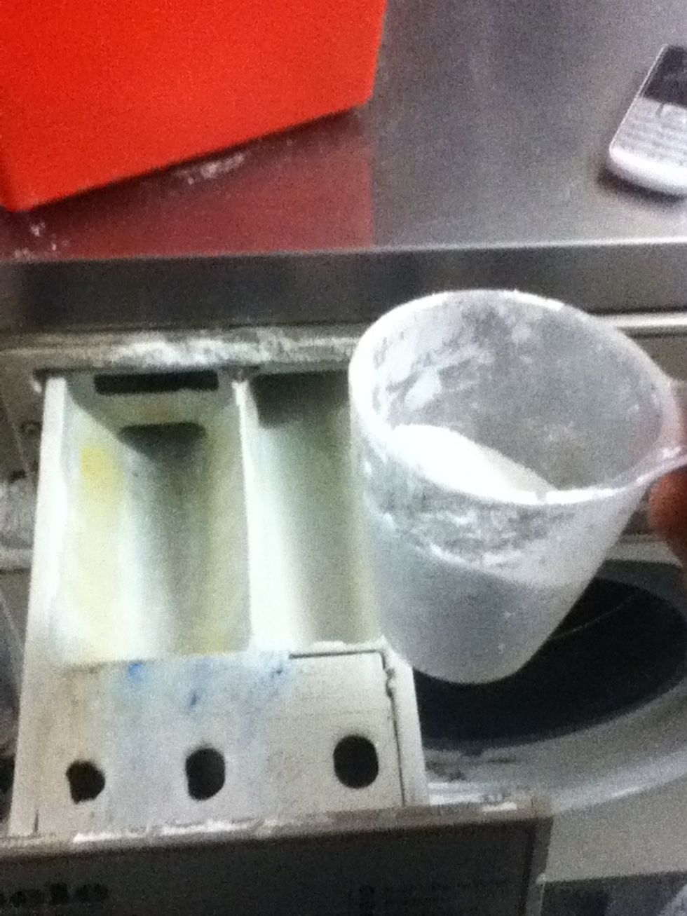 Add washing powder in the slot above the door