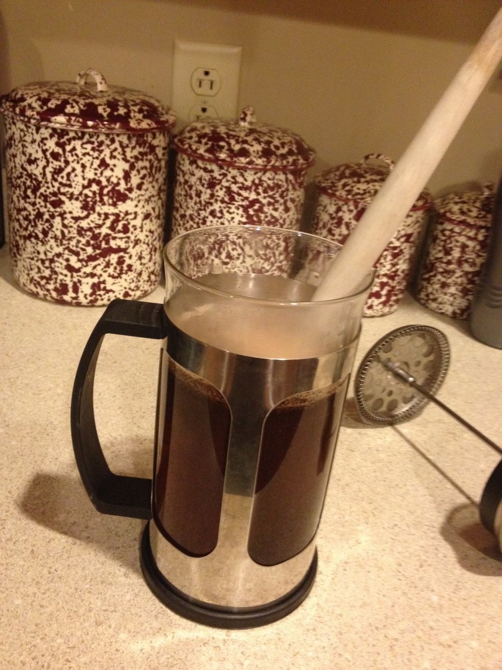 Add water and mix coffee with wooden spoon for one minute.