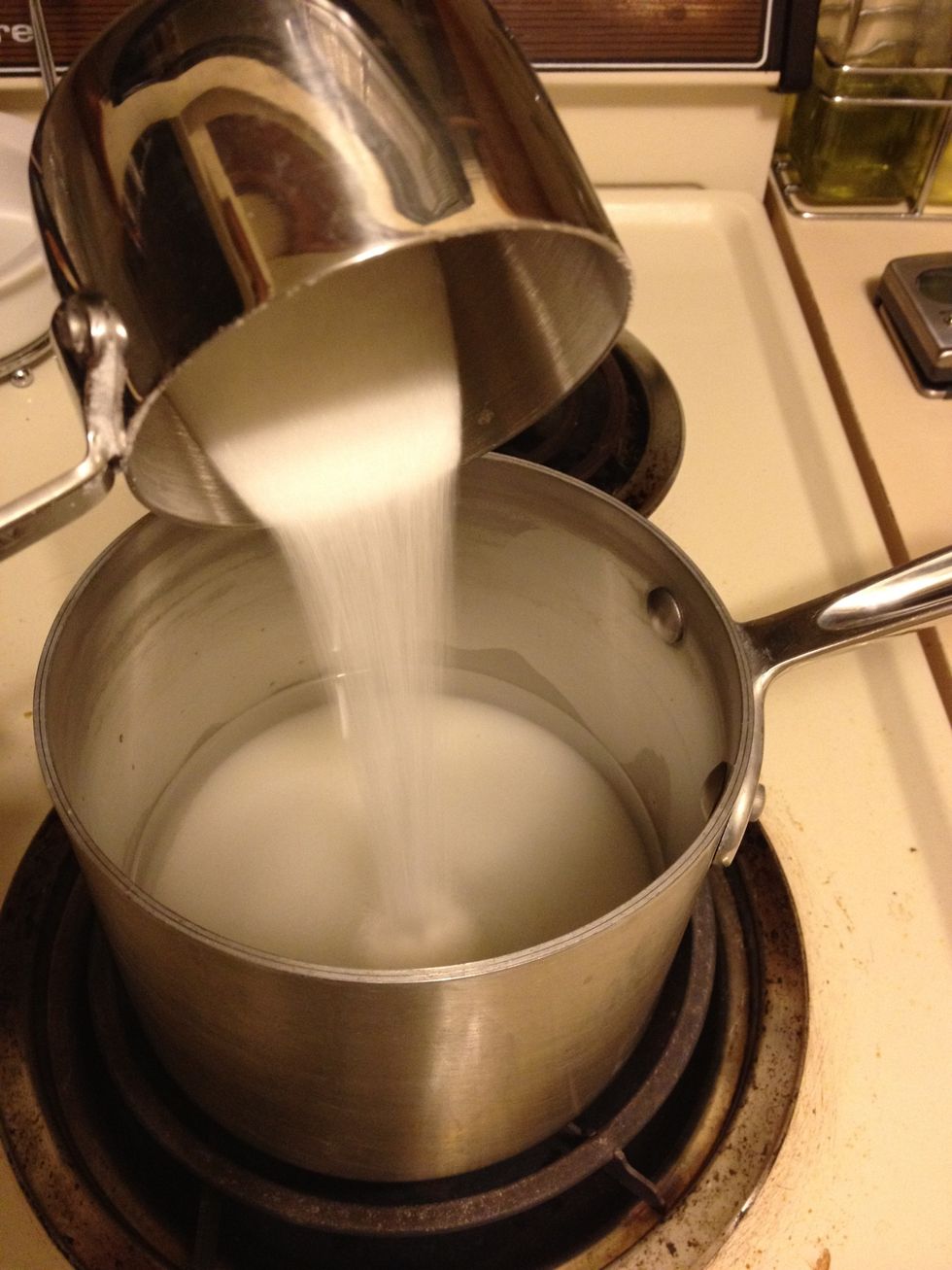 Add water and sugar to a small pot. Turn burner to medium-high heat. Stir with a whisk often.