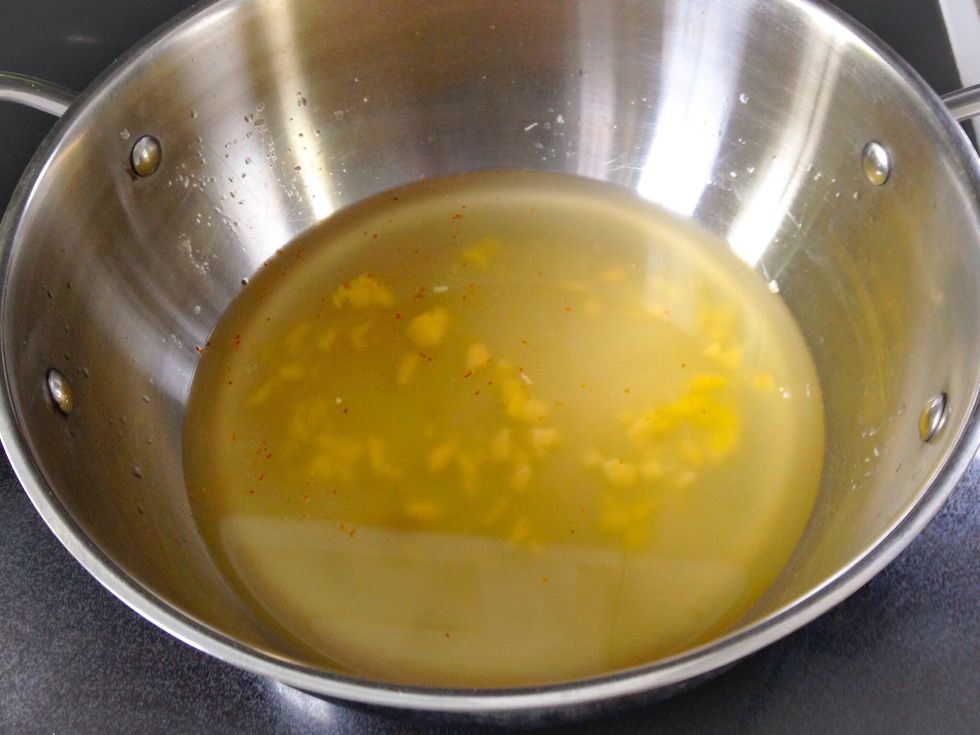 Add water, ginger, garlic and red chili flakes to pot. Bring to a boil.