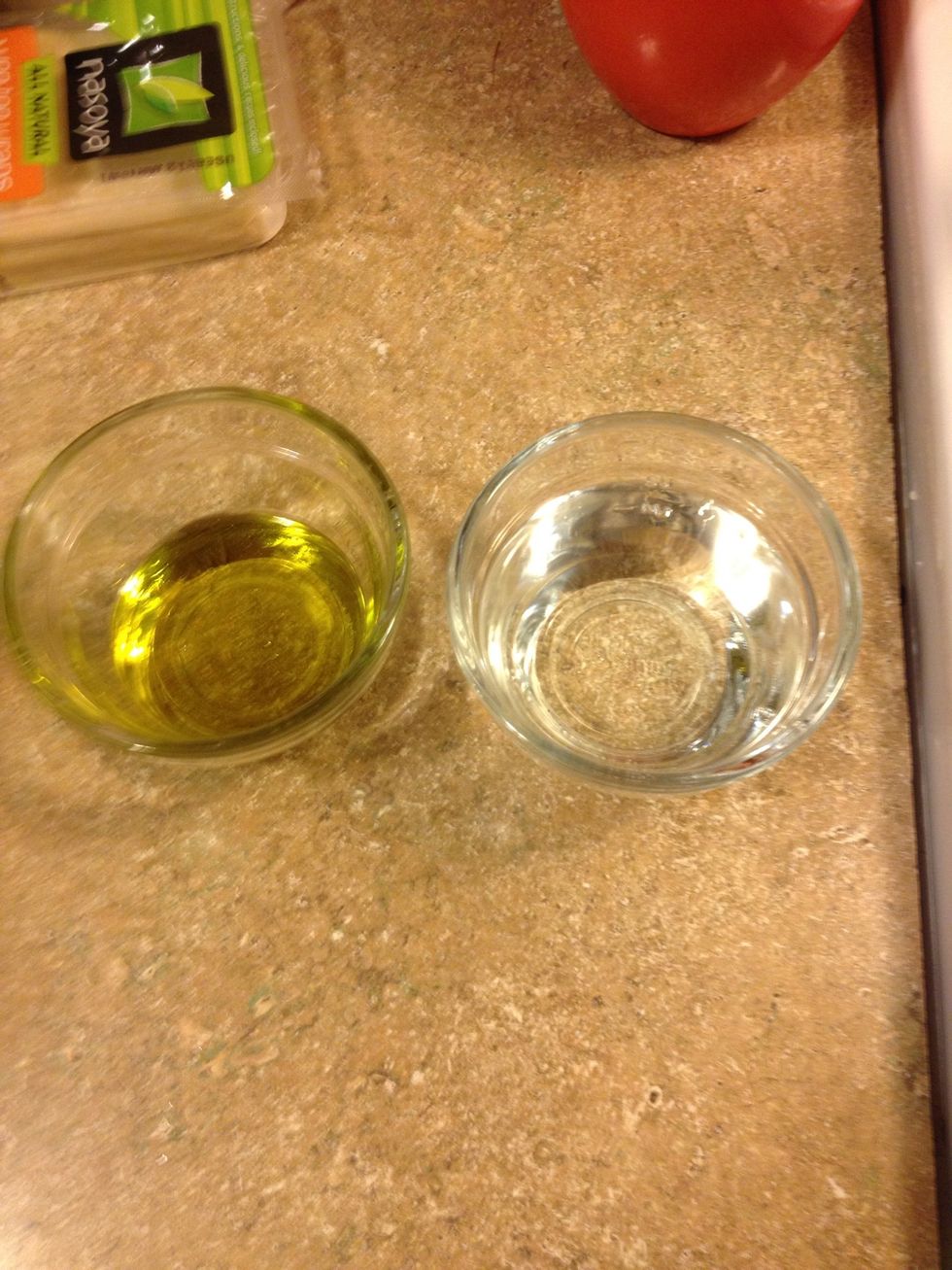 Add water to a bowl and oil to another