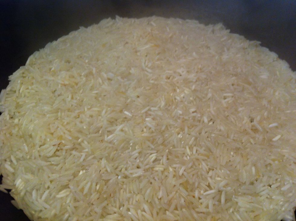 Add water to cover rice and some salt and olive oil; mix constantly and add water as needed