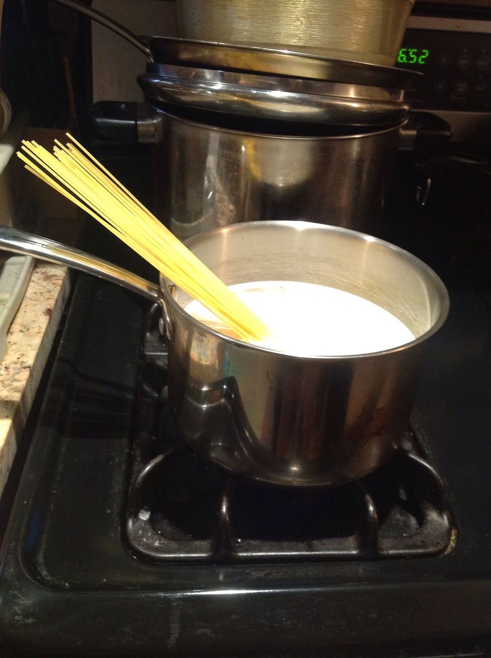 Add water to your pot and put on the stove to boil. Add butter, oil, and the spaghetti to the pot. Add salt to taste.