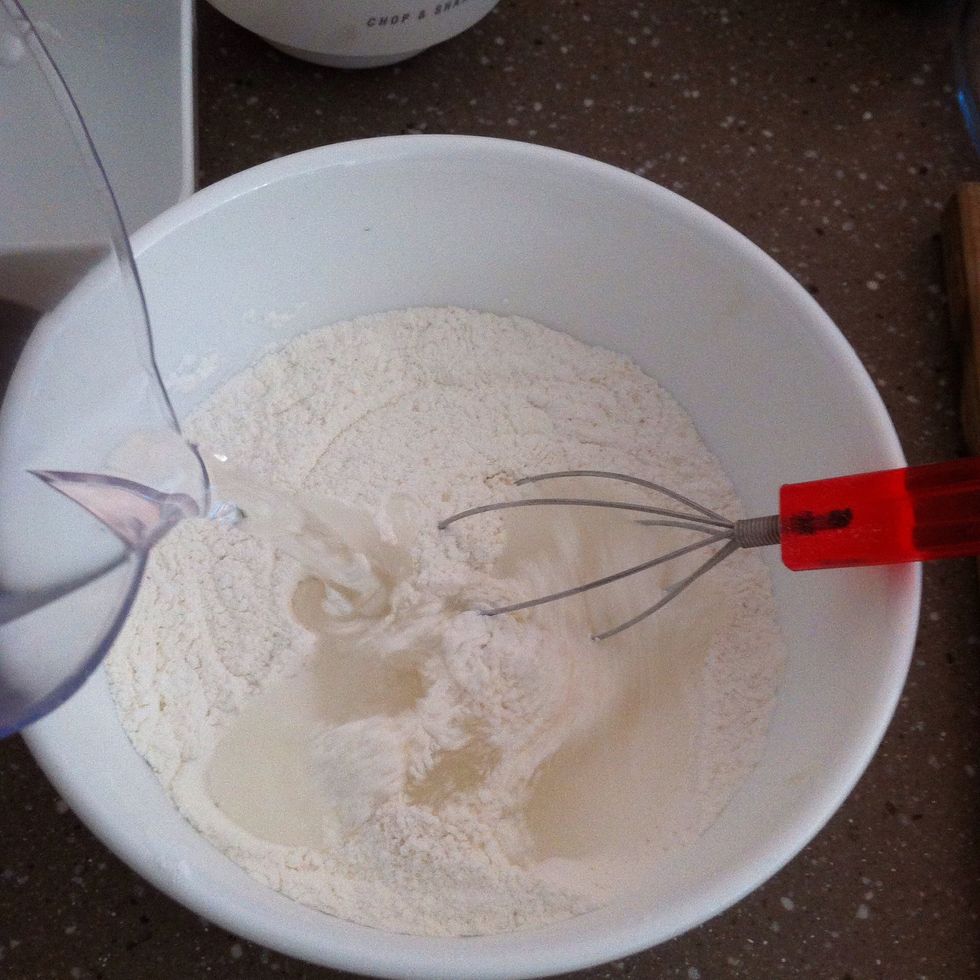 Add water while whisking rapidly. At this stage you can add colour or liquid flavourings in small amounts (although remember steaming may affect them)