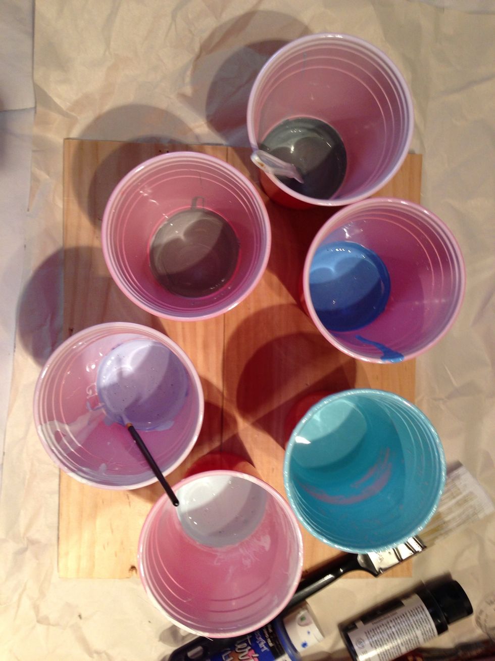 Add white and black to blue paint to make various shades of blue and gray.