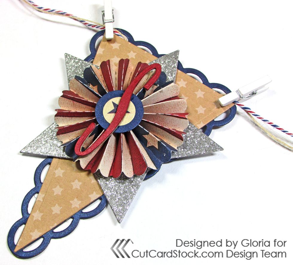 Add white clothespins to the "S" pennant. The twine is one strand of natural burlap and one strand of red/white/blue baker's twine.