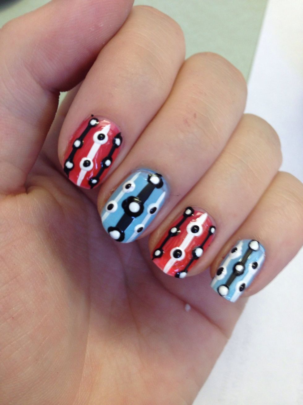 Add white dots to all the black ones on your nails. I like doing the whole hand at once instead of switching colors and tools to do one nail at a time. Then go through and add black dots to white dots