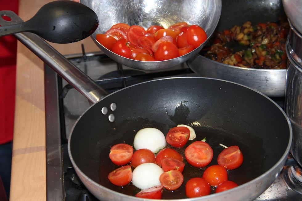 Add white onions and the cut cherry tomatoes