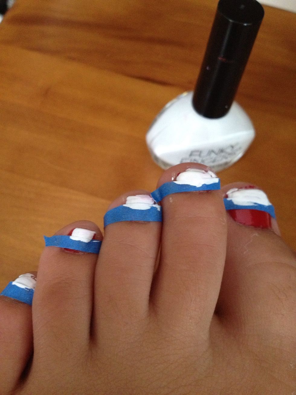 Add white to the top part of the nails above the tape. It is ok if the white nail polish touches the tape it just can't go over.