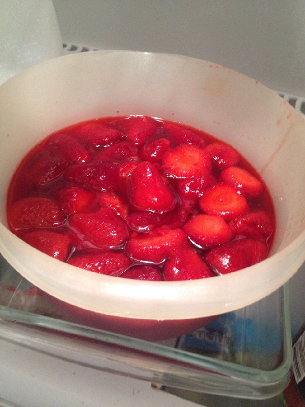 Add whole strawberries to jello and refrigerate until slightly set.