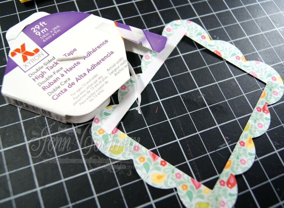 Add Xyron 1/4" High Tack Tape to the back of the decorative die cut frame front.  Add this decorative frame to over top of the acetate on the front of the foam frame.