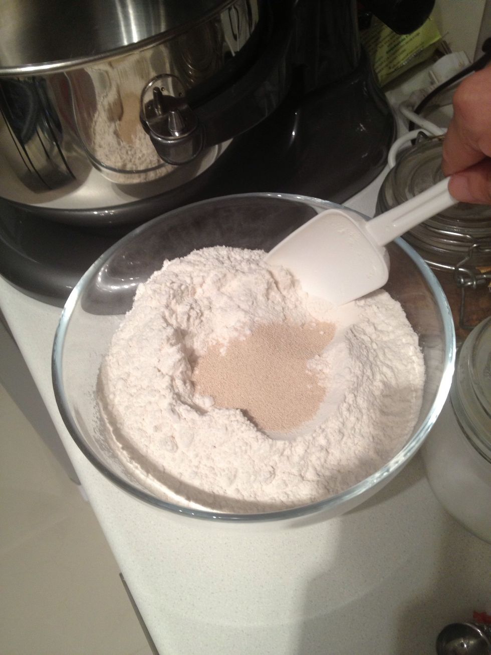 Add yeast and stir into the flour and put them in the mixer bowl. I use kitchenaid pro 600, which can take up to 12 cups of flour. A normal 5 quart mixers can handle 6 cups of flour.