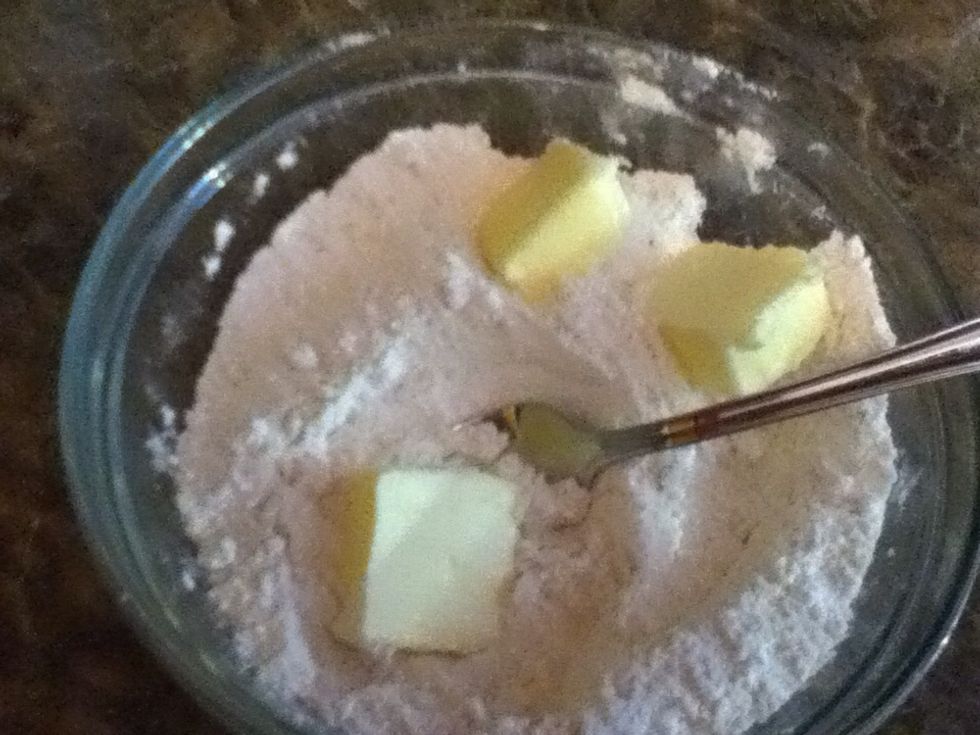 Add your butter. Use a fork or your fingers to mix it until it reaches the texture of crumbs.