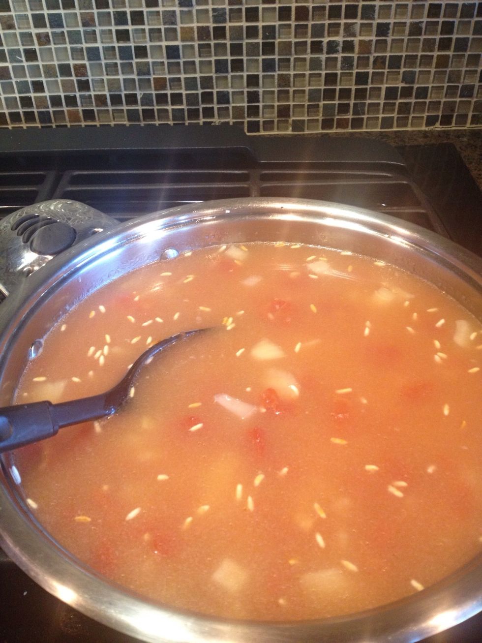 Add your chicken stock/broth. At this point you'll see any pieces of burned rice that you may have missed float to the top. Quick! Get em'! This is your last chance.