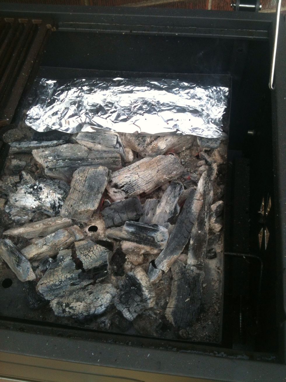 Add your chip package to the coals. If using loose chips place them on the coals around the edge so you don't take away any heat. I placed mine in the back on some coals.