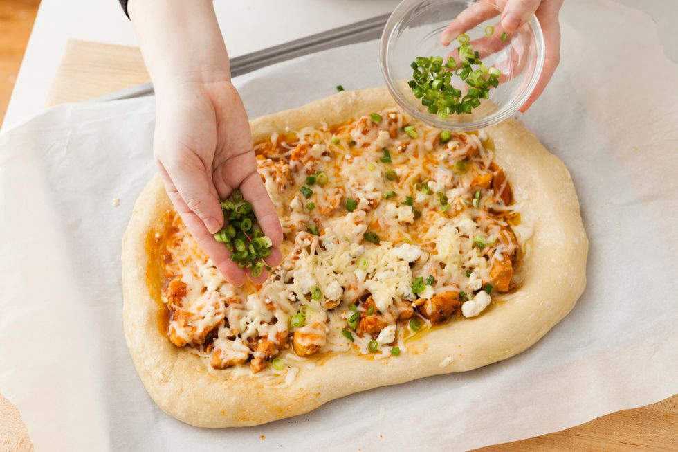 Add your chopped scallions to the top of the crust.