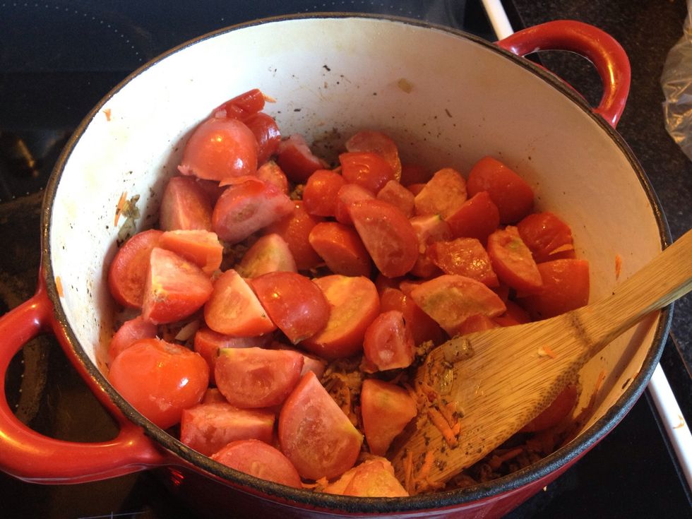Add your chopped tomatoes to the pot and stir. If you're not keen on finding bits of tomato skin in your meal, you can pur\u00e9e the tomato instead. Or just deal with it; skin is good!