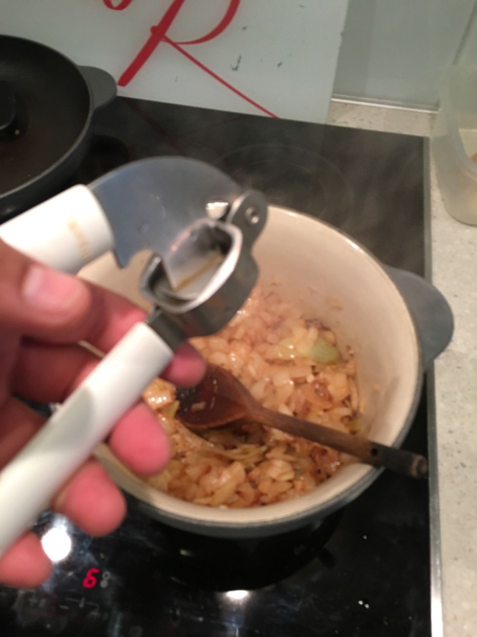 Add your cloves of garlic, crushed of course. Add more to taste.