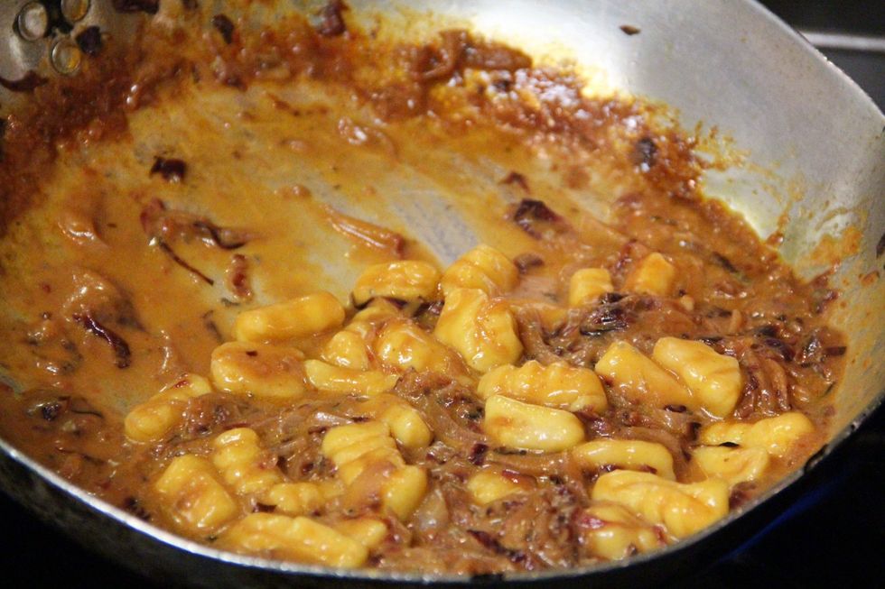 Add your cooked gnocchi. Gnocchi should be cooked till they float..2/3 minutes in hot boiling salted water. Start tossing around till you get a nice consistency