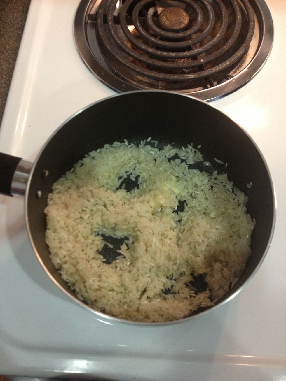 Add your cup of rice and fry it a little bit make sure not to burn it.