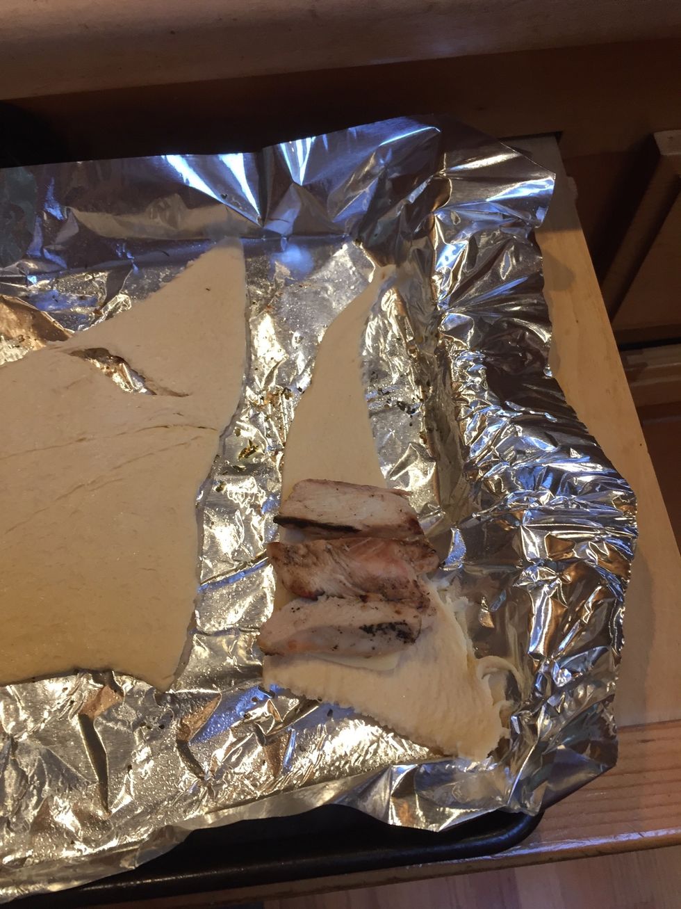 Add your cut up chicken. You can add more things to the croissant. I would have added spinach if I had any around. If you don't want the butter glaze on top, add spices to the middle in this step.