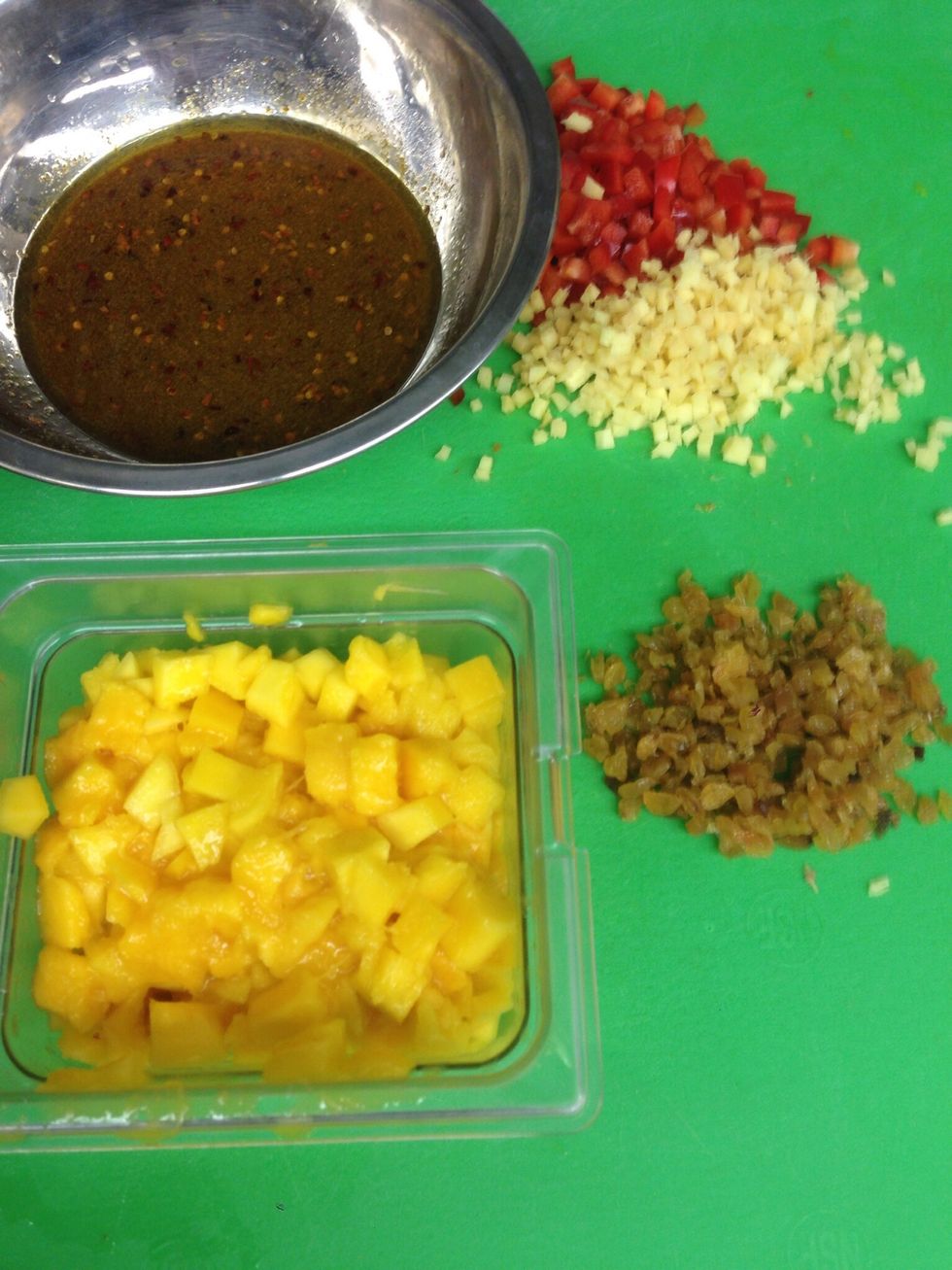 Add your diced mango, ginger, red pepper, red onions, and chopped golden raisins to your mixture.
