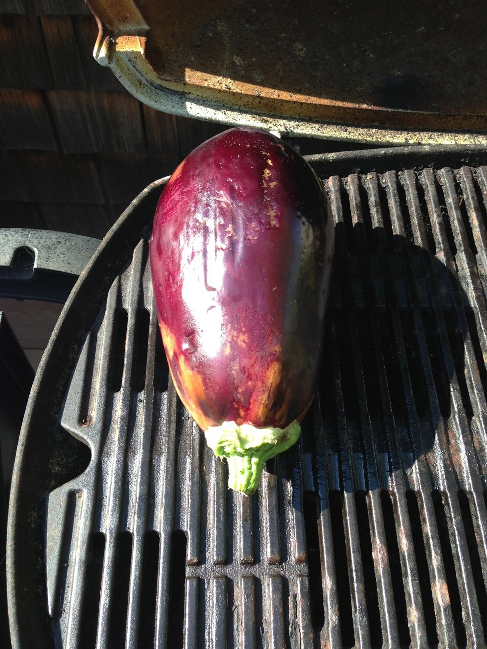 Add your eggplant to the grill and cook covered, turning every 5-10 minutes, until it is blackened and quite flat. It will take 20-30 minutes. Note: I'd recommend making 3-4 eggplants, I just had one!