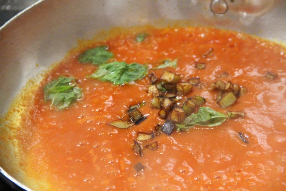 Add your eggplant to the sauce...not all. Keep some for the end for garnishing
