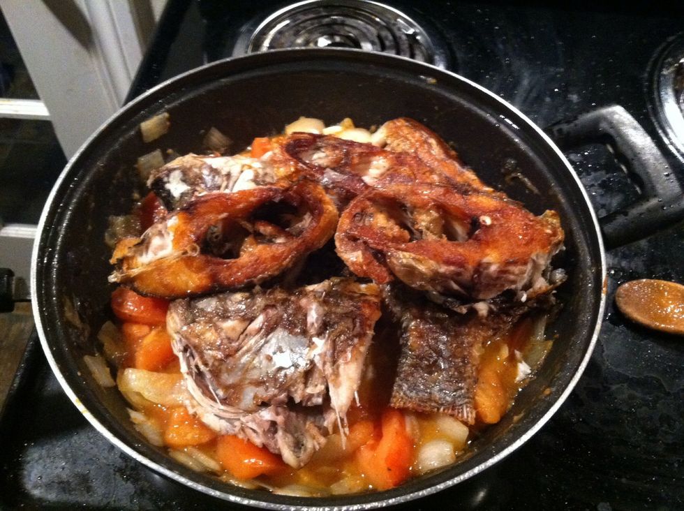 Add your fry fish try to delicately pour some of the tomatoes and onion on top of it