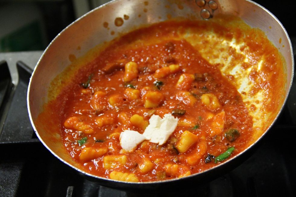 Add your gnocchi that you cooked in salted boiling water till the started floating...2/3 minutes. Add a few cubes of mozzarella but not all...