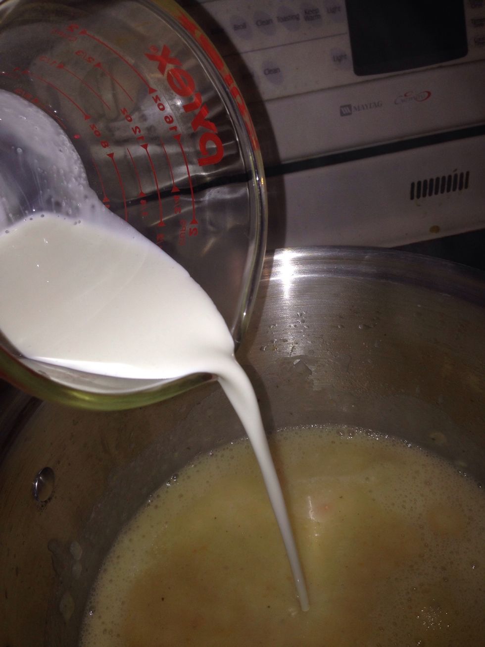 Add your heavy cream. Add your salt and Cajun seasoning to taste. Stir. Let it simmer for about 5 minutes.