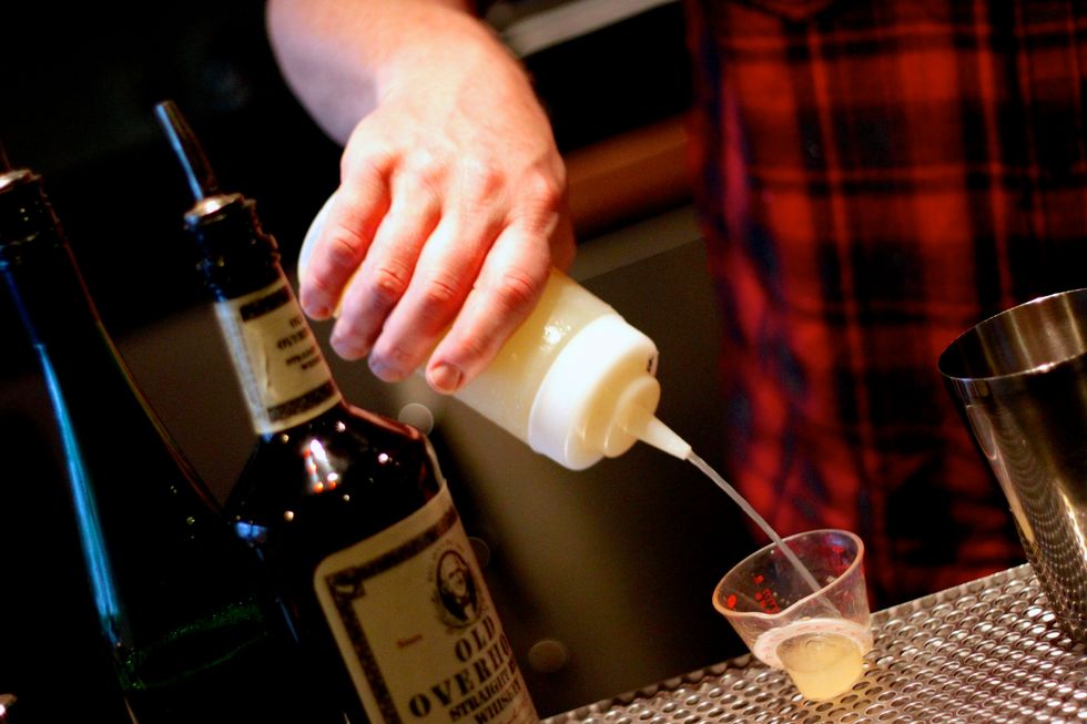 Add your lemon juice to a shaker.