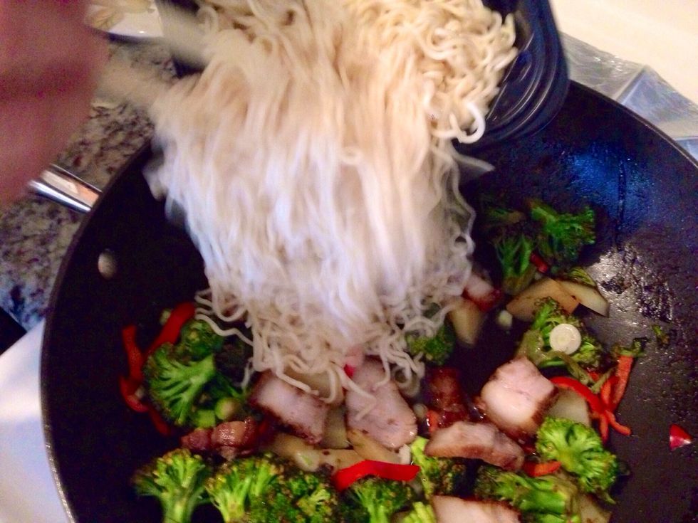Add your meat to the wok and add your cooked noodles. To make it easy, you can use the packaged noodles.