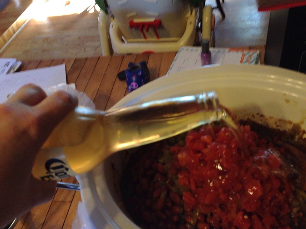 Add your Mexican beer. If you want a thicker chili you can pour less beer into the chili. Stir everything up.