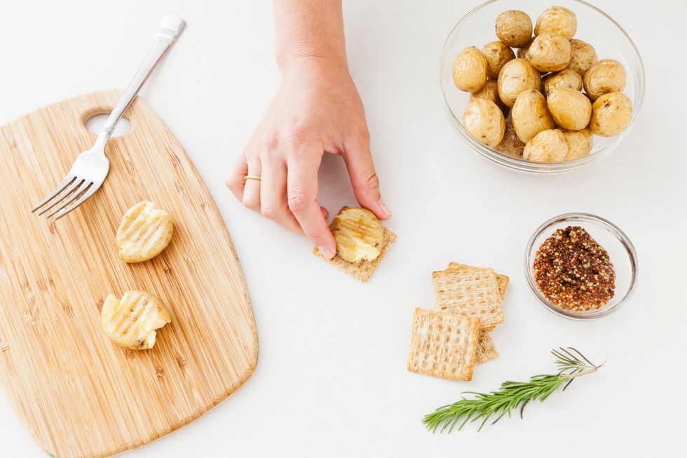 Add your mini smashed potato to your Triscuit cracker.