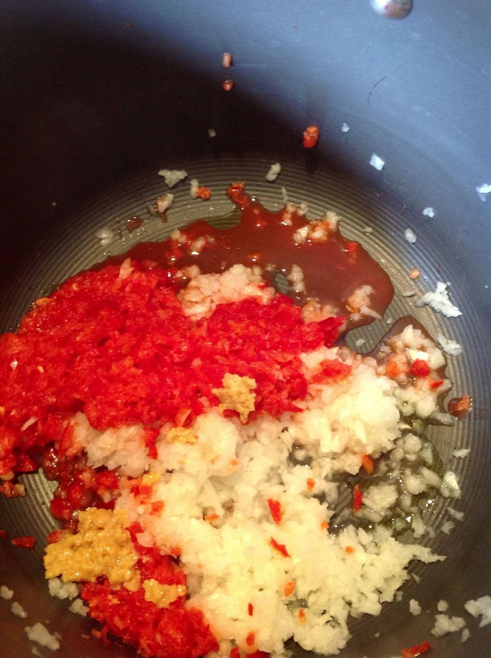Add your onion, red pepper and garlic. Cook until onions are translucent.