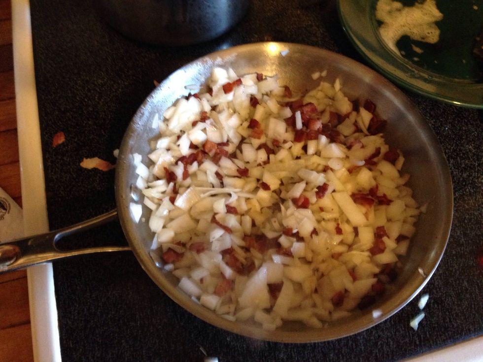 Add your onions and stir the bacon with the onions.