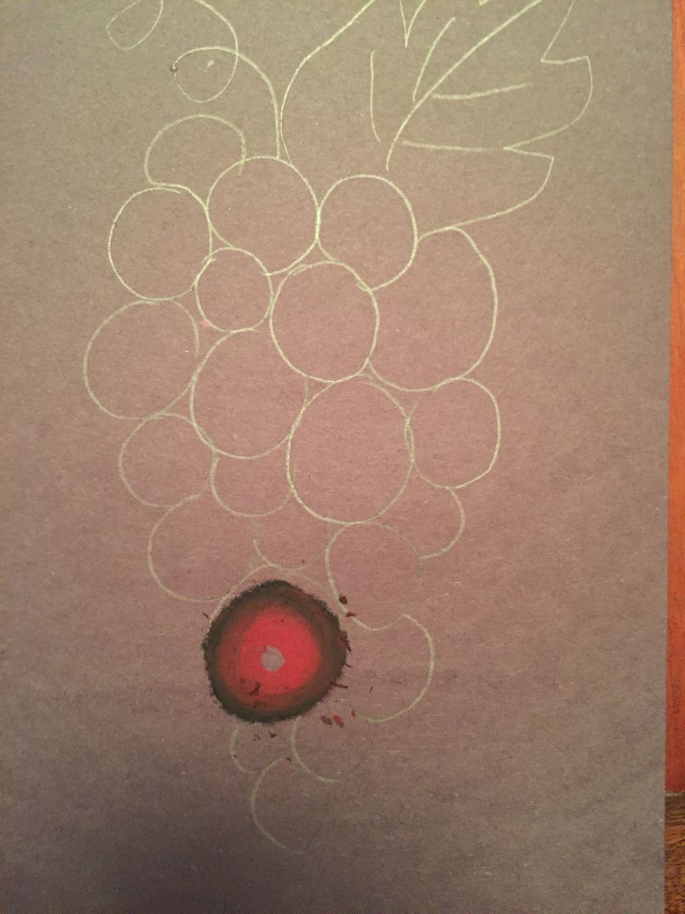 Add your red. Remember to blend the red with the black by going on top of the black. Press hard.