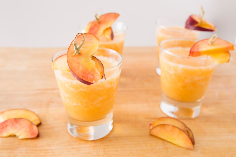 Add your slushie to desired glasses and garnish with fresh peach slices.