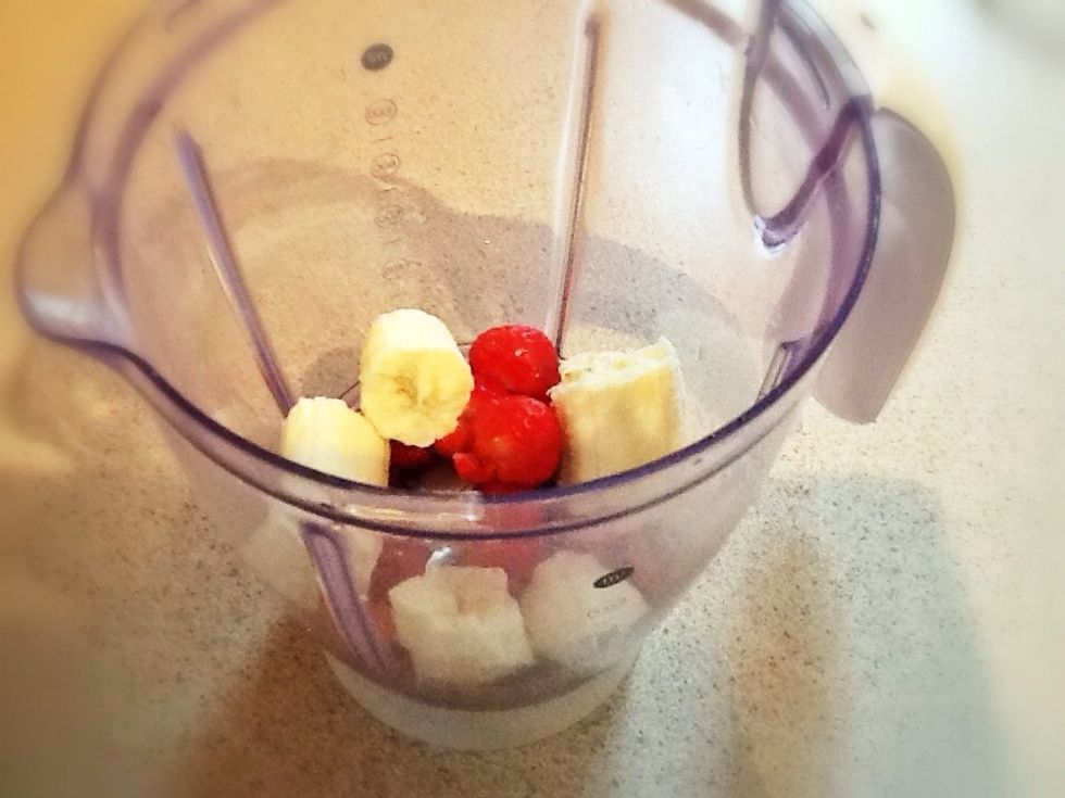 Add your strawberries and banana to your blender - break up the banana into chunks as you add it!