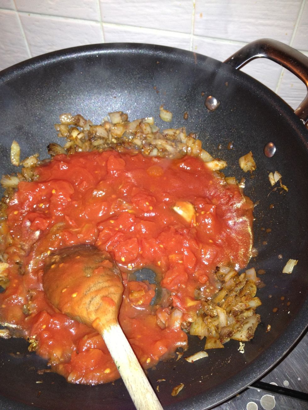 Add your tin of chopped tomatoes, and teaspoon of Chana masala powder.